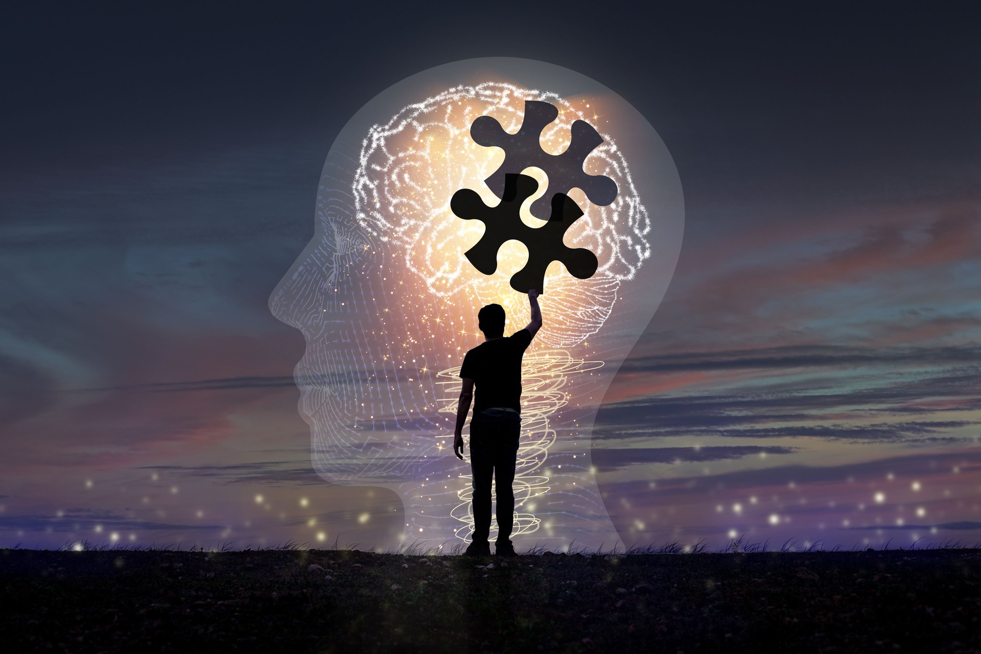 A young man's silhouette is piecing together a jigsaw puzzle. in brain icon concept creativity and innovation
